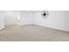 View of a large basement area featuring neutral carpeting, white walls, and a decorative compass on the wall at 297 N Coolidge Way, Aurora, CO 80018