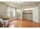 Basement bedroom showcasing hardwood floors, a closet with shelving, and a window for natural light at 297 N Coolidge Way, Aurora, CO 80018