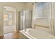 Bright bathroom with a soaking tub, glass shower and a window with a view at 297 N Coolidge Way, Aurora, CO 80018
