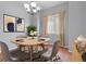 Dining area boasts stylish decor with modern accents, a light wood table, and neutral-toned chairs at 297 N Coolidge Way, Aurora, CO 80018