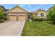 Charming two-story home with stone accents, a well-manicured lawn, and a two car attached garage at 297 N Coolidge Way, Aurora, CO 80018