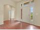 Bright and airy foyer with hardwood floors, arched doorway, and transom windows above the entrance at 297 N Coolidge Way, Aurora, CO 80018