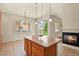 Bright kitchen and living room area features an island with granite countertop and a fireplace at 297 N Coolidge Way, Aurora, CO 80018