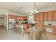 Well-appointed kitchen featuring wood cabinets, stainless steel appliances, island with seating, and stylish pendant lighting at 297 N Coolidge Way, Aurora, CO 80018