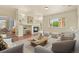 Spacious living room featuring a fireplace, large window, neutral tones, and an open layout, perfect for entertaining at 297 N Coolidge Way, Aurora, CO 80018