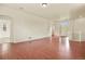 Spacious living area with hardwood floors, white walls, and a seamless flow to the foyer and kitchen at 297 N Coolidge Way, Aurora, CO 80018