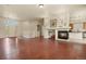 Bright and open living space with fireplace, hardwood floors, and seamless flow into other living areas at 297 N Coolidge Way, Aurora, CO 80018