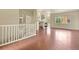 Open-concept living area with hardwood floors, white staircase, and fireplace, offering a cozy gathering space at 297 N Coolidge Way, Aurora, CO 80018