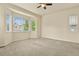 Spacious main bedroom features large windows with neighborhood views and soft carpet at 297 N Coolidge Way, Aurora, CO 80018