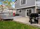 Backyard view with a grill and deck area with a table and chairs at 5261 S Malta Way, Centennial, CO 80015