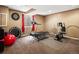 Spacious basement transformed into a home gym with a treadmill and other equipment at 5261 S Malta Way, Centennial, CO 80015