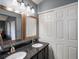 Elegant bathroom with double sinks, granite countertops, modern cabinets, and a view of a linen closet at 5261 S Malta Way, Centennial, CO 80015