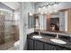 Bathroom featuring granite countertops, double sinks, modern cabinets, and walk-in shower at 5261 S Malta Way, Centennial, CO 80015