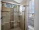 Bathroom featuring glass-enclosed walk-in shower with tile surround and built-in shelving at 5261 S Malta Way, Centennial, CO 80015