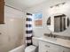 Bright bathroom with a vanity, a view of a window, a mirror and a shower/tub combination at 5261 S Malta Way, Centennial, CO 80015