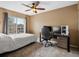 Spare bedroom with large window, neutral carpet, ceiling fan and modern desk setup at 5261 S Malta Way, Centennial, CO 80015