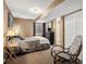 A bedroom features carpeted floors, a television, and a connected bathroom at 5261 S Malta Way, Centennial, CO 80015