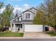 Charming gray two-story home featuring a well-manicured lawn and attached two-car garage at 5261 S Malta Way, Centennial, CO 80015