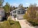 Aerial view of a gray, two-story home with a well-kept lawn and a two-car garage in a suburban setting at 5261 S Malta Way, Centennial, CO 80015