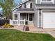 Charming two-story home with a well-maintained lawn and a cozy front porch, perfect for relaxing at 5261 S Malta Way, Centennial, CO 80015