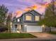 Stunning two-story home with a well-manicured lawn and warm exterior lighting, creating an inviting ambiance at 5261 S Malta Way, Centennial, CO 80015