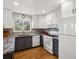 Updated kitchen features a gas range, tile backsplash, stainless appliances and hardwood floors at 5261 S Malta Way, Centennial, CO 80015