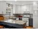 Well-equipped kitchen with white appliances, gray tile backsplash, and ample counter space at 5261 S Malta Way, Centennial, CO 80015