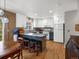 Bright kitchen featuring white cabinets, a center island with bar seating, and hardwood floors at 5261 S Malta Way, Centennial, CO 80015