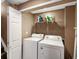 Laundry room with washer, dryer, and storage shelf at 5261 S Malta Way, Centennial, CO 80015