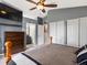 Spacious main bedroom with a ceiling fan, a tv, and multiple closets and a view of the ensuite at 5261 S Malta Way, Centennial, CO 80015