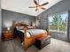 Comfortable main bedroom features a fan, a window with a view, and an ensuite bathroom at 5261 S Malta Way, Centennial, CO 80015