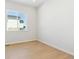 Minimalist bedroom with hardwood floors and abundant natural light at 13805 Emerald Lake St, Parker, CO 80138