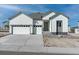 Charming home with white siding, gray trim, and a spacious two-car garage offering modern curb appeal at 13805 Emerald Lake St, Parker, CO 80138