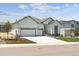 Charming home featuring a three-car garage, well-maintained lawn, and welcoming curb appeal at 13805 Emerald Lake St, Parker, CO 80138
