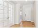 Bright hallway featuring elegant french doors and stunning hardwood floors at 13805 Emerald Lake St, Parker, CO 80138