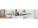 Modern kitchen with white cabinets, island, and stainless steel appliances at 13805 Emerald Lake St, Parker, CO 80138
