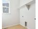 Bright laundry room with built-in shelving and window at 13805 Emerald Lake St, Parker, CO 80138