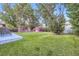 Lush backyard with a red shed, chicken coop, and mature trees at 2982 S Vrain St, Denver, CO 80236