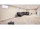 Finished basement with a large black leather couch and glass coffee table on the neutral carpet at 2982 S Vrain St, Denver, CO 80236