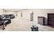 Finished basement with plush carpet, a black leather couch, and a mini fridge at 2982 S Vrain St, Denver, CO 80236