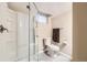 Bathroom featuring a glass enclosed shower, toilet, decorative towel bar, and modern tile flooring at 2982 S Vrain St, Denver, CO 80236
