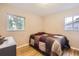 Bedroom with hardwood floors, two windows, and neutral wall color at 2982 S Vrain St, Denver, CO 80236