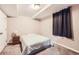 Simple bedroom with neutral paint, plush carpet, and single window with black out curtains at 2982 S Vrain St, Denver, CO 80236