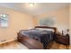 Comfortable bedroom with wood floors, neutral walls, and a large window for natural light at 2982 S Vrain St, Denver, CO 80236
