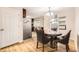 Bright eat-in kitchen with wood floors, stainless steel refrigerator, and views to the backyard at 2982 S Vrain St, Denver, CO 80236
