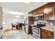 Modern kitchen with stainless steel appliances, and an adjacent dining area at 2982 S Vrain St, Denver, CO 80236