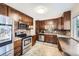 Updated kitchen with stainless steel appliances and dark wood cabinets at 2982 S Vrain St, Denver, CO 80236