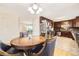 Eat-in kitchen features stainless appliances, dark cabinets, and a wood dining table set at 2982 S Vrain St, Denver, CO 80236