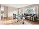 Bright living room with hardwood floors, large windows, and neutral-toned furniture at 2982 S Vrain St, Denver, CO 80236
