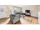 Inviting living room with hardwood floors, large window, and comfortable seating area at 2982 S Vrain St, Denver, CO 80236